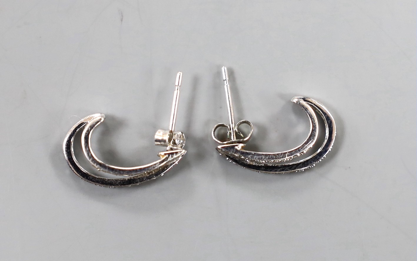 A modern pair of 375 white metal and diamond set two row half hoop earrings, 15mm, gross 2.1 grams.